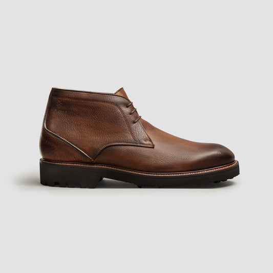 Brown leather chukka boot on a rubber lug sole